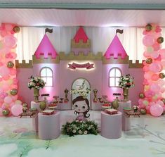 a pink princess castle birthday party with balloons and decorations