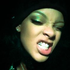 a close up of a person with her mouth open and tongue out in the dark