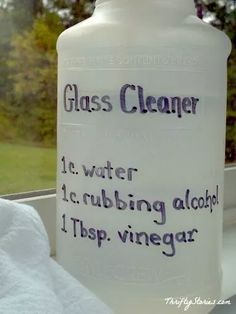 a glass cleaner bottle sitting on top of a window sill