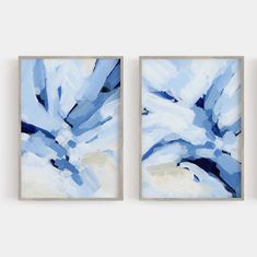 two blue paintings hanging on the wall next to each other