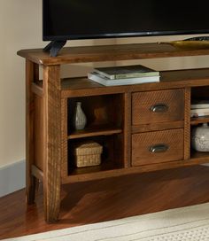 an entertainment center with drawers and a flat screen tv