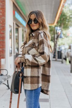 Details Shacket season is here & our Karlie Brown Plaid Flannel Shacket features a neutral brown and taupe classic plaid print that goes with everything! Dress this super soft shacket over an LBD for your next event to achieve a western-inspired boho look, or throw it on over a casual jogger set to add a dash of chic to your casual style! Collared Long sleeves Button-down front closure Two front flap pockets 100% Polyester Machine wash cold Color: Brown Colors may vary on different viewing devic Flannel Outfit Women, Brown Flannel Outfit, Brown Plaid Flannel, Shacket Outfit, Brown Flannel, Flannel Shacket, Casual Joggers, Brown Plaid, Jogger Set