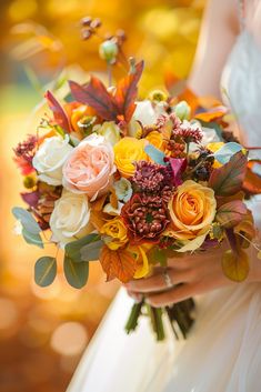 a woman holding a bouquet of flowers in her hands