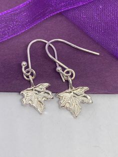 Hand made solid fine silver maple leaf drops with sterling silver ear wires. Small enough for everyday wear, walking the dog or in the office, they could also set off a special outfit on a night out. Worn either as a symbol of nature, woodlands or Canada these earrings will fit the bill!  Handmade in the heart of Sherwood Forest this silver item is one of only a few similar items. Nothing is mass produced so there can be slight differences between each item which is part of their handmade charm. Nickel Free Leaf-shaped Sterling Silver Jewelry, Nickel Free Leaf-shaped Sterling Silver Earrings, Nickel-free Sterling Silver Leaf-shaped Earrings, Nickel Free Sterling Silver Leaf-shaped Earrings, Hypoallergenic Sterling Silver Leaf-shaped Earrings, Nickel-free Leaf-shaped Sterling Silver Earrings, Nickel-free Leaf-shaped Sterling Silver Jewelry, Sterling Silver Leaf-shaped Jewelry With Ear Wire, Silver Leaf-shaped Jewelry With Ear Wire