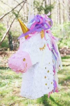 a unicorn pinata hanging from a string