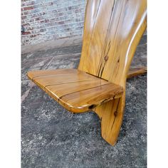 a wooden chair sitting on top of a cement floor