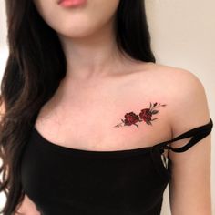 a woman with a rose tattoo on her shoulder