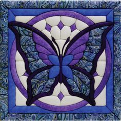 a purple and white butterfly with blue accents on it's wings is featured in this quilt