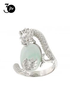 a white gold ring with an aqua green jade stone and diamonds on the band, set in