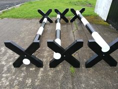 four black and white sculptures sitting on the ground