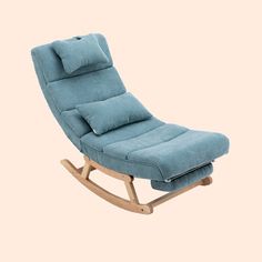 a blue rocking chair with pillows on it