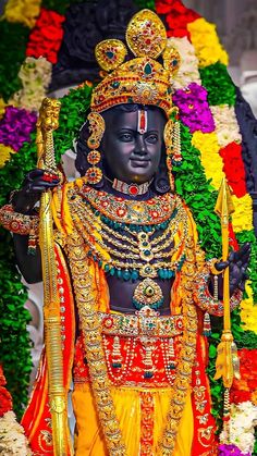 an idol is displayed in front of flowers