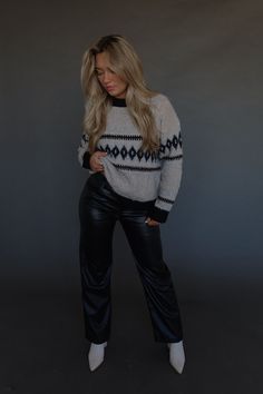 DETAILS: Our Maeva Cable Knit Sweater is a stand out piece for your wardrobe! This sweater has a twisted detail throughout the sweater that adds a unique and eye-catching element to its design. The neckline is a high scoop and there is a thick black trim on the neckline, cuffs, and hemline. The sweater has small cable knit and very soft to touch material. It has stretch and runs true to size. Pair this sweater with leggings or jeans and your favorite boots for a cute outfit!! CONTENT & CARE: 47% Polyester. 35% Acrylic. 15% Nylon. 3% Spandex. SIZE & FIT: Model is 5'6" The model is wearing a size small. Fits true to size The Fabric has stretch Chic Stretch Chunky Knit Sweater, Knit Top For Night Out In Fall, Trendy Knit Sweater For Night Out, Trendy Knit Top For Winter Nights Out, Trendy Knit Top For Night Out In Winter, Fall Crew Neck Knit Top For Night Out, Trendy Sweater For Fall Night Out, Trendy Cropped Sweater For Winter Nights, Trendy Cropped Sweater For Night Out In Winter