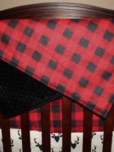 a red and black plaid baby crib bedding set with deer head on it