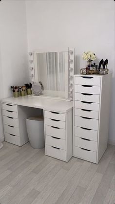 there is a white vanity with many drawers