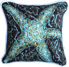 a decorative pillow with an aqua and brown starfish design