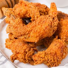 fried chicken rings on a white plate next to a glass of milk