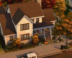 a white car parked in front of a house with autumn foliages on the ground