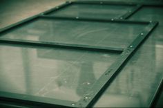 three metal frames sitting next to each other on top of a table with water droplets all over them