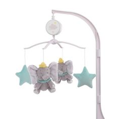 an elephant mobile with stars hanging from it