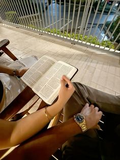 a person sitting on a chair reading a book