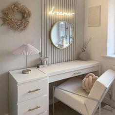 a white desk topped with a mirror and a chair