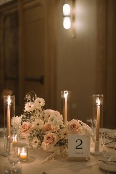 the table is set with flowers and candles for an elegant wedding reception or special event