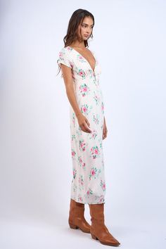 Discover effortless charm with our Floral V-Neck Front Tie SS Midi Dress. Featuring a delicate floral print and a modern v-neck with tie detail, this dress is both stylish and comfortable. With its short sleeves and back zipper, it's easy to slip on and off. Perfect for any occasion, the straight long midi dress is a must-have addition to your wardrobe. Material: 100% Rayon / Lining: 100% Polyester Chic Floral Print V-neck Dress For Brunch, V-neck Midi Dress With Ditsy Floral Print For Summer, Elegant V-neck Midi Dress With Ditsy Floral Print, Chic Flowy V-neck Dress With Floral Print, Ditsy Floral Print V-neck Dress For Garden Party, Chic Floral Printed V-neck Dress, Floral Print V-neck Dress For Summer Brunch, Chic V-neck Floral Dress For Brunch, Chic V-neck Dress With Notched Neckline And Floral Print