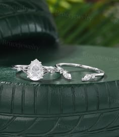 two engagement rings sitting on top of a tire