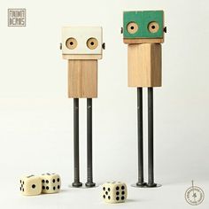 two wooden toy figures with dices in front of them on a white background,