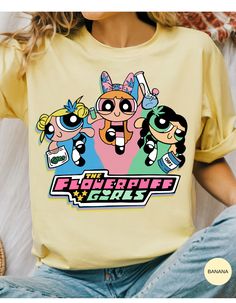 the powerpuff girls t - shirt is shown on a woman's chest