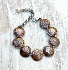 "THIS ITEM IS IN STOCK AND SHIPS  VIA USPS MAIL AMERICAN HERITAGE COLLECTION Indian Head Penny- minted 1859-1909 The perfect gift for any one who loves American history or vintage coins! This is a lovely bracelet made with 8 domed and polished Indian Head pennies. Made with alternating heads and tails (because the back is just as beautiful as the front). The pennies are connected with stainless steel links. It closes with a stainless steel lobster claw clasp and is finished with a freshwater pea Etched Coin Jewelry For Anniversary, Heirloom Bracelet Collectible Jewelry, Heirloom Collectible Bracelet Jewelry, Heirloom Nickel-free Collectible Jewelry, Heirloom Nickel-free Jewelry For Collectibles, Antique Adjustable Jubilee Bracelet, Engraved Heirloom Metal Jewelry, Heirloom Hallmarked Metal Jewelry, Antique Coin Jewelry For Vintage Collection