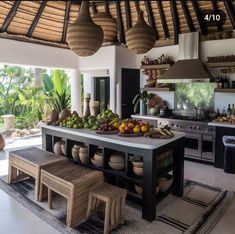 a kitchen with an island and lots of food on the counter top in front of it