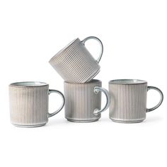 four coffee mugs stacked on top of each other with one cup in the middle