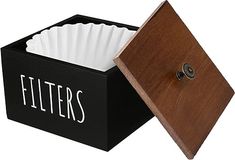 a black box with white napkins in it and a wooden lid that says filters