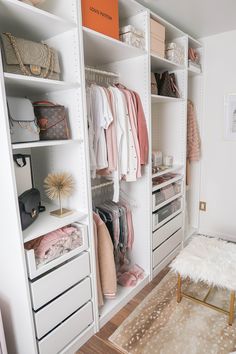 an organized closet with white shelving and drawers