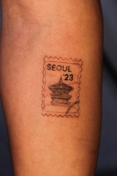 a stamp with the word seoul on it and an image of a pagoda in the background