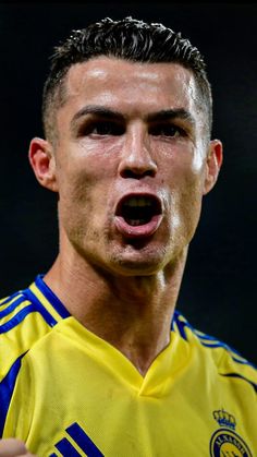 a soccer player with his mouth open in front of the camera, making a goofy face