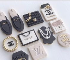 the cookies are decorated with chanel, gucci, and other things on them