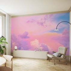 a living room with a couch, chair and painting on the wall that is painted in pastel colors