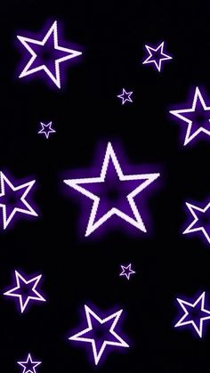 purple and white stars are arranged in the shape of a star on a black background