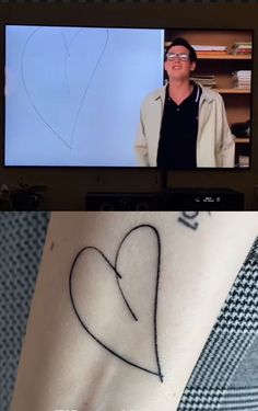 a person with a heart tattoo on their arm