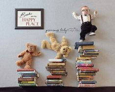 two teddy bears sitting on top of a pile of books next to a sign that says happy place