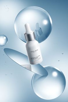 an image of a bottle of skin care product in the air with bubbles around it