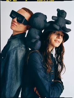 a man and woman are posing for a photo with hats on their heads while wearing sunglasses