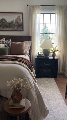 a bedroom with a bed, nightstand and window