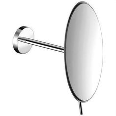 an oval mirror mounted to the side of a metal wall mount sink faucet