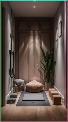 a room that has a yoga mat on the floor next to a potted plant