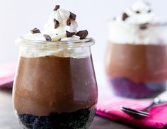 two desserts in jars with whipped cream and chocolate