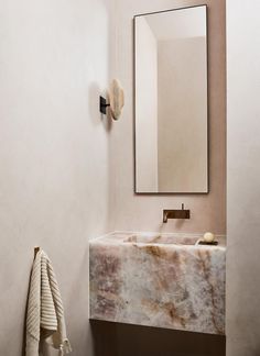 a marble sink and mirror in a bathroom